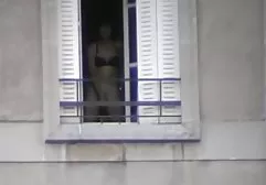 Naked fashion model posing by the sea