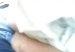 Chick masturbates with a dildo fixed on the guy's face