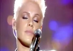 A girl with a beautiful body walks naked along the embankment